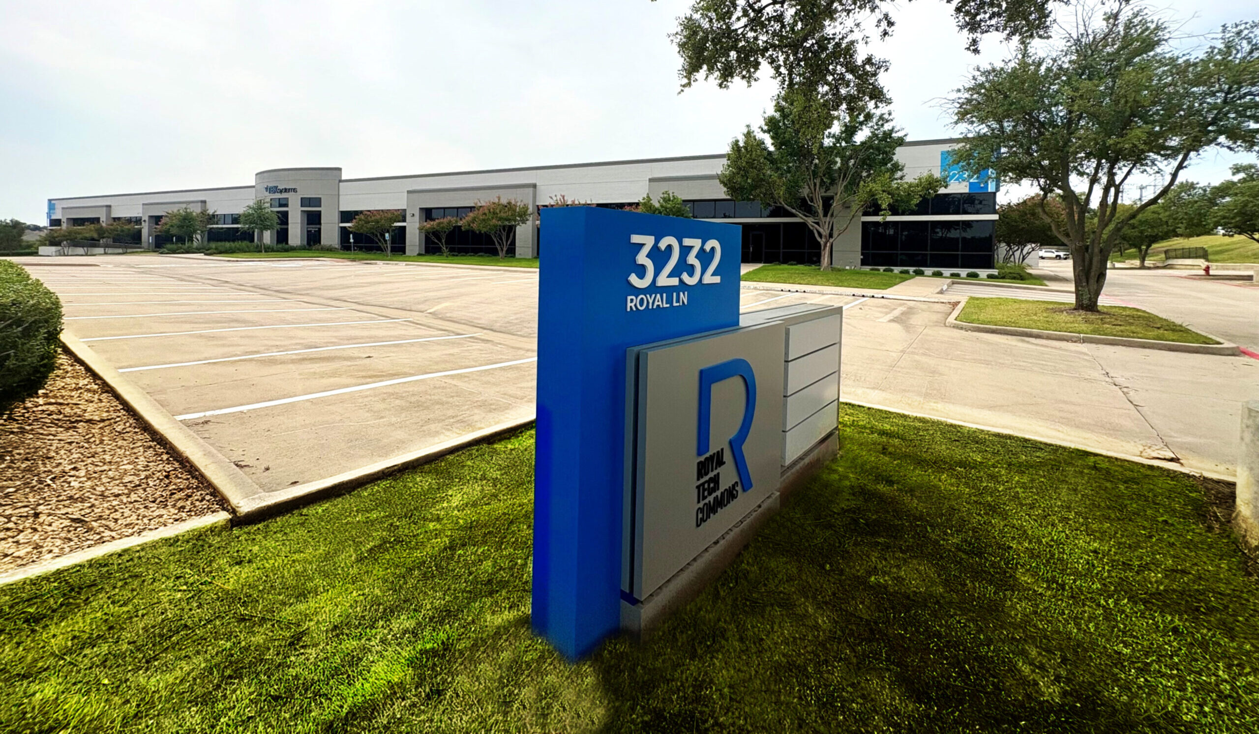 Wide view exterior shot of building and signage 3232 W Royal Lane